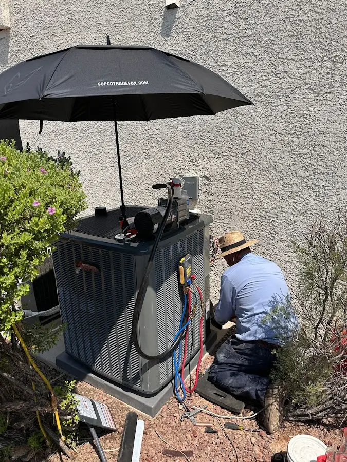 HVAC technician performing outdoor AC maintenance in Sturgis